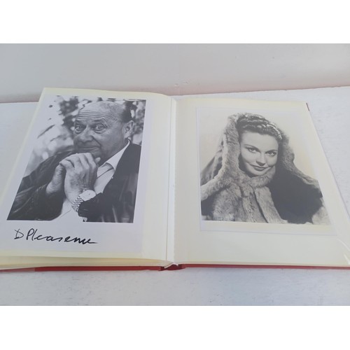 396 - A photo album containing signed film photographs.