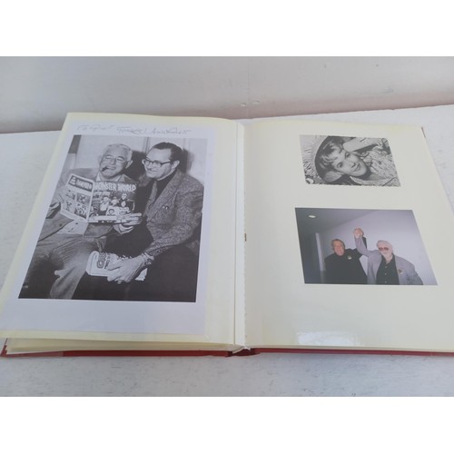 396 - A photo album containing signed film photographs.