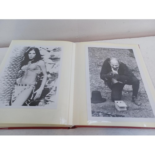 396 - A photo album containing signed film photographs.