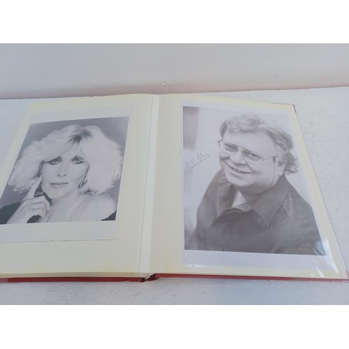 396 - A photo album containing signed film photographs.