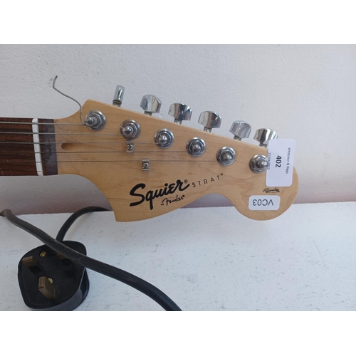 402 - Two items, one Squier Affinity sunburst Stratocaster electric guitar and one Squier SP10 practice am... 