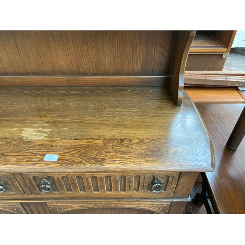 7 - An oak dresser with upper plate rack, two drawers and two lower cupboard doors - approx. 90cm high x... 