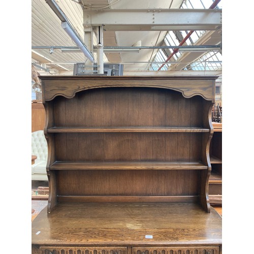 7 - An oak dresser with upper plate rack, two drawers and two lower cupboard doors - approx. 90cm high x... 