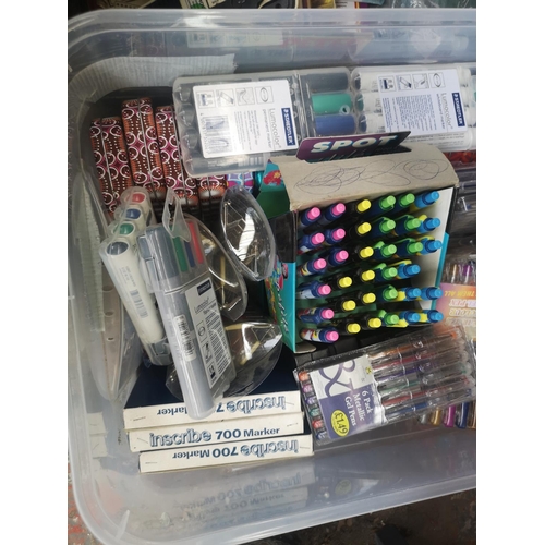 590 - Two boxes containing a collection of assorted items to include pens, comics etc.