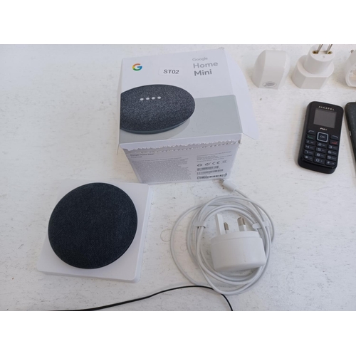 370 - A collection of tech items to include boxed Google home mini, Alcatel mobile phone, boxed Garmin Dri... 