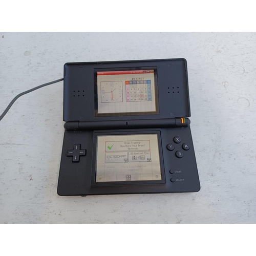 371 - A Nintendo DS Lite with charger and brain training game cartridge.