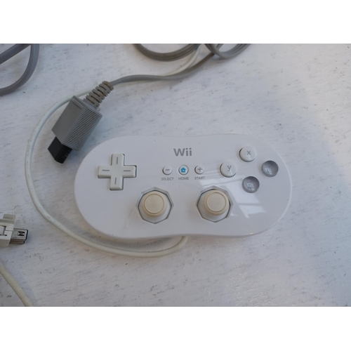 375 - A collection of Nintendo Wii items to include console, charging stand, Wii remotes, power adapter, n... 