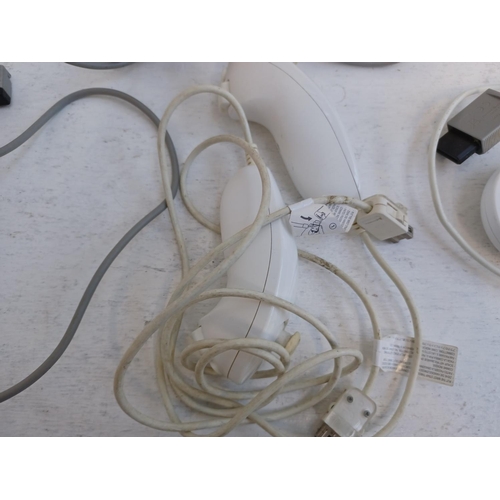 375 - A collection of Nintendo Wii items to include console, charging stand, Wii remotes, power adapter, n... 