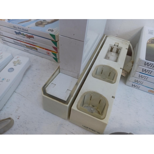 375 - A collection of Nintendo Wii items to include console, charging stand, Wii remotes, power adapter, n... 