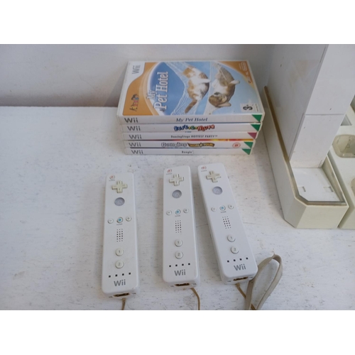 375 - A collection of Nintendo Wii items to include console, charging stand, Wii remotes, power adapter, n... 