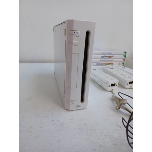 375 - A collection of Nintendo Wii items to include console, charging stand, Wii remotes, power adapter, n... 