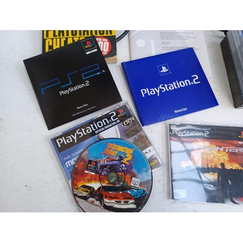 379 - A collection of Sony PlayStation items to include PS2 console, game discs, controllers, memory card,... 