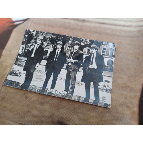 390A - Two The Beatles items, one Topstar Portraits TS131 black and white postcard/photograph and one Revei... 