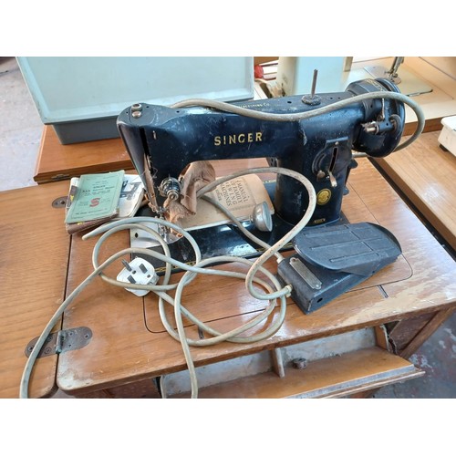 462 - A sewing table containing Singer 201K electric sewing machine with foot pedal, light and instruction... 