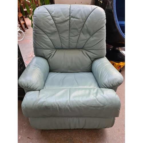 246A - A green leather reclining armchair