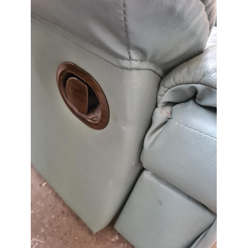 246A - A green leather reclining armchair