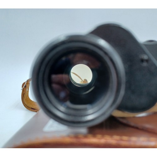 223 - A cased pair of Carl Zeiss Jenoptem 8 x 30w binoculars