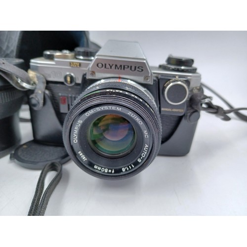 232 - Four Olympus items, one cased Camedia E-10 4mp digital camera, one cased OM-10 35mm SLR camera fitte... 