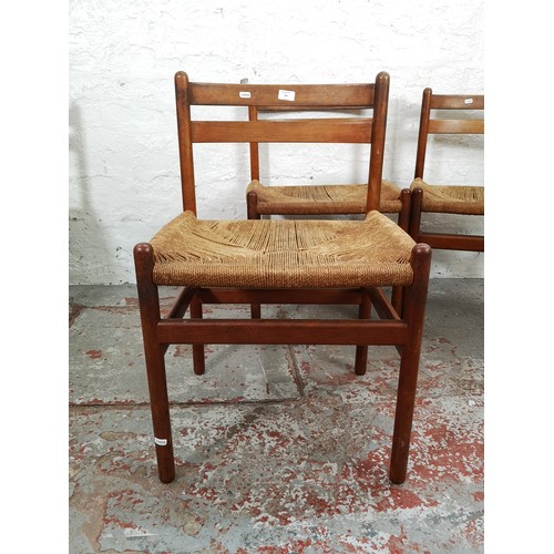 54 - A set of four mid 20th century Danish teak and rush seated dining chairs - approx. 76cm high x 50cm ... 