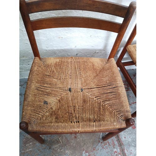 54 - A set of four mid 20th century Danish teak and rush seated dining chairs - approx. 76cm high x 50cm ... 