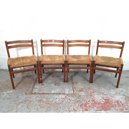 54 - A set of four mid 20th century Danish teak and rush seated dining chairs - approx. 76cm high x 50cm ... 