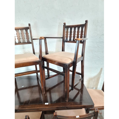 56 - An Ercol dark oak and beech draw leaf dining table and six matching chairs - approx. 74cm high x 71c... 