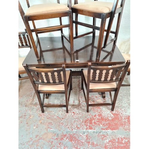 56 - An Ercol dark oak and beech draw leaf dining table and six matching chairs - approx. 74cm high x 71c... 