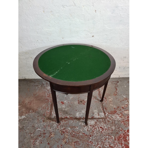 90 - An Edwardian mahogany demi lune folding card table with green baize interior - approx. 72.5cm high x... 