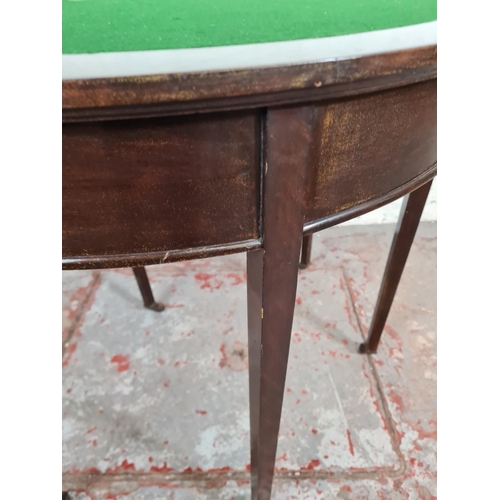 90 - An Edwardian mahogany demi lune folding card table with green baize interior - approx. 72.5cm high x... 