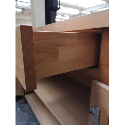 107 - A modern solid beech sideboard with two upper drawers and two lower cupboard doors - approx. 95cm hi... 