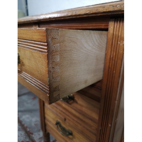 113 - A late Victorian Aesthetic Movement oak writing desk with green leather insert and castors - approx.... 