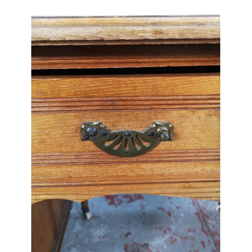 113 - A late Victorian Aesthetic Movement oak writing desk with green leather insert and castors - approx.... 