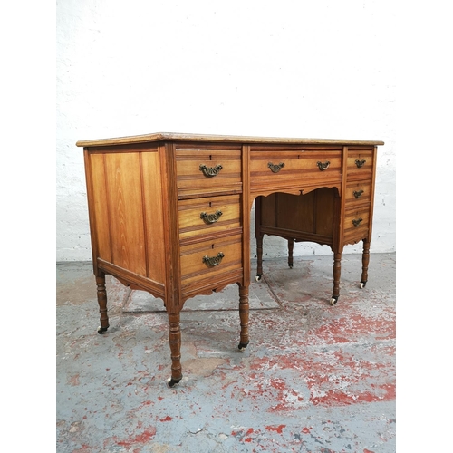 113 - A late Victorian Aesthetic Movement oak writing desk with green leather insert and castors - approx.... 