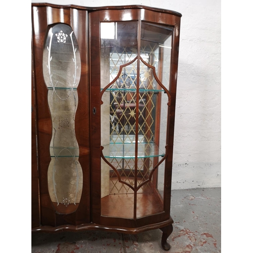 119 - A walnut two door display cabinet with two glass shelves - approx. 119cm high x 104cm wide x 35cm de... 