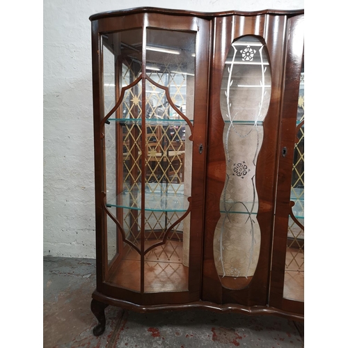 119 - A walnut two door display cabinet with two glass shelves - approx. 119cm high x 104cm wide x 35cm de... 