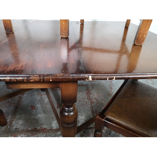 124 - An oak drop leaf gate leg dining table and four matching chairs - approx. 72cm high x 90cm wide x 14... 