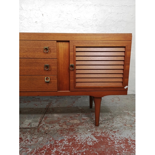 133 - An Elliotts of Newbury teak sideboard with three central drawers and two outer cupboard doors - appr... 