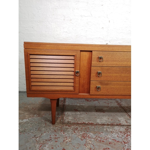 133 - An Elliotts of Newbury teak sideboard with three central drawers and two outer cupboard doors - appr... 