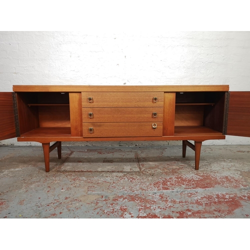 133 - An Elliotts of Newbury teak sideboard with three central drawers and two outer cupboard doors - appr... 