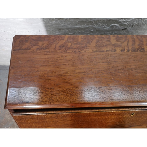 155 - A mid/late 20th century oak bureau with three drawers, fall front and cabriole supports - approx. 10... 