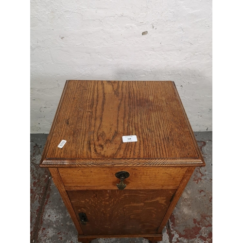 168 - A 1930s oak bedside cabinet - approx. 80cm high x 40cm wide x 37cm deep