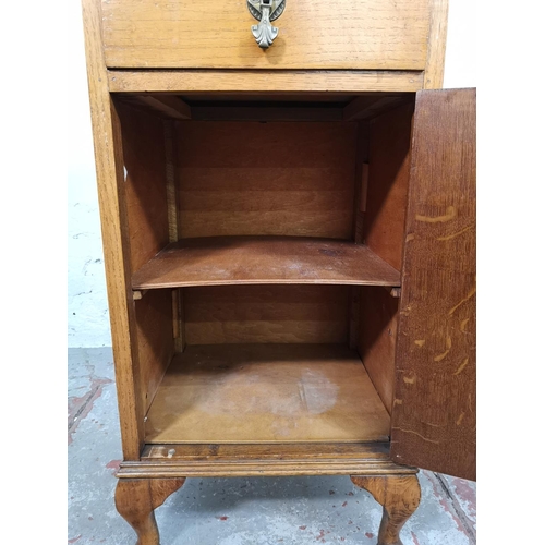 168 - A 1930s oak bedside cabinet - approx. 80cm high x 40cm wide x 37cm deep