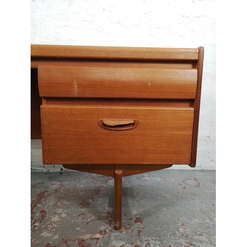 18 - A mid 20th century teak four drawer dressing table - approx. 68cm high x 155cm wide x 41cm deep