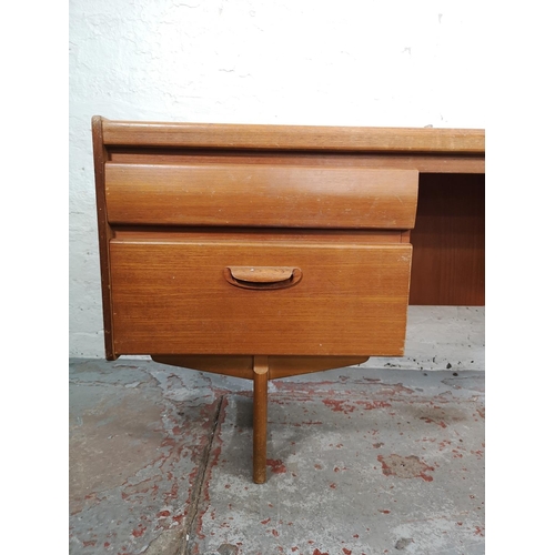 18 - A mid 20th century teak four drawer dressing table - approx. 68cm high x 155cm wide x 41cm deep