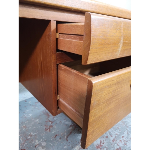 18 - A mid 20th century teak four drawer dressing table - approx. 68cm high x 155cm wide x 41cm deep