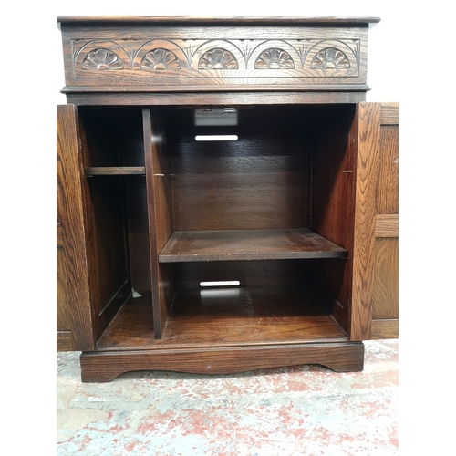 19 - A Jaycee oak linen fold two door cabinet with hinged lid - approx. 88cm high x 74cm wide - 48cm deep