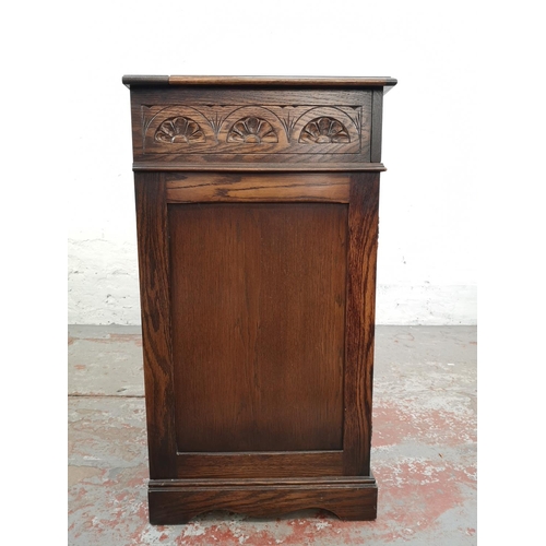 19 - A Jaycee oak linen fold two door cabinet with hinged lid - approx. 88cm high x 74cm wide - 48cm deep