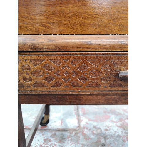 21 - A mid 20th century oak concertina sewing box on stand with single drawer and castors - approx. 58cm ... 