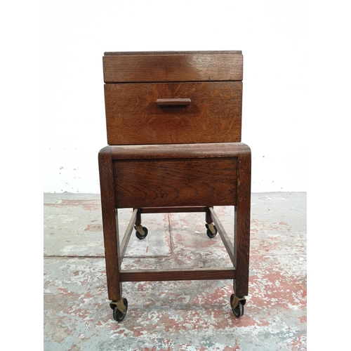 21 - A mid 20th century oak concertina sewing box on stand with single drawer and castors - approx. 58cm ... 