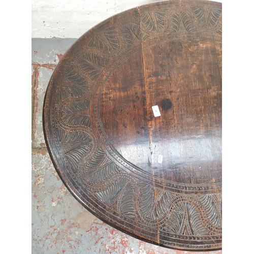 22 - A 17th century style carved oak drop leaf gate leg oval occasional table with single drawer - approx... 